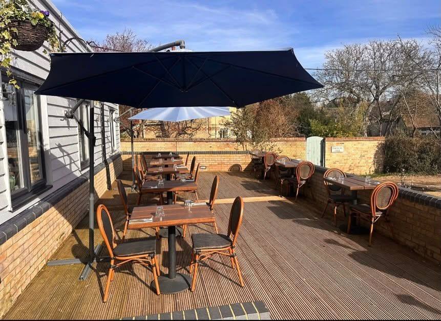 Outdoor decking and seating area at Wood Grill at The Queen Adelaide